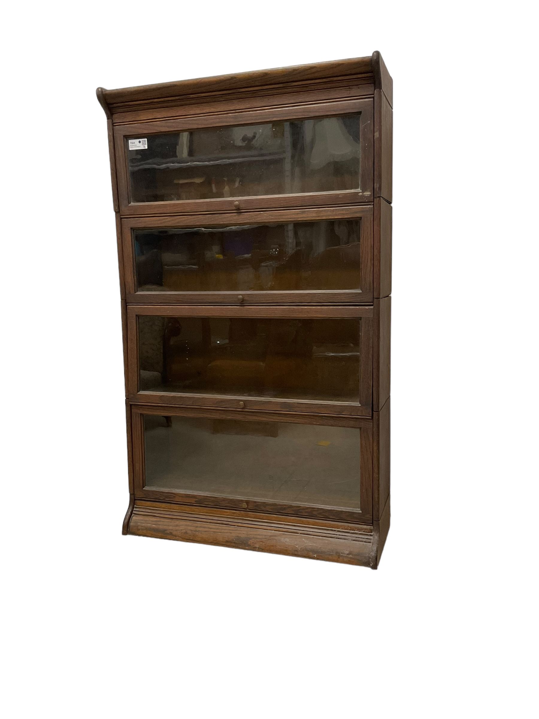 Early 20th century oak Globe Wernicke design sectional library bookcase, four sections each with hinged sliding glazed door, on moulded base 