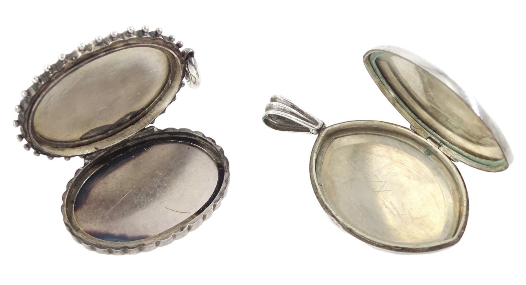 19th / early 20th century silver hinged locket, with applied wirework and engraved butterfly and foliate decoration and one other silver locket, with monogrammed decoration