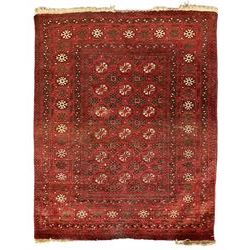 Antique Persian crimson ground rug, the field decorated with Gul motifs, the guarder border with stylised stars in ivory and dark indigo