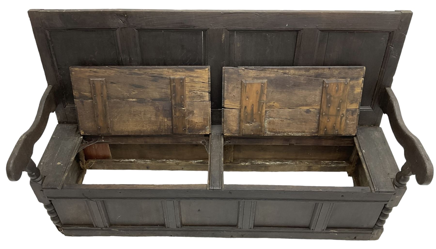 18th century oak box seat settle bench, pegged construction with quadruple panelled back over double hinged box seat, shaped projecting arms with scroll carved terminal detail, on block and bobbin turned front supports, panelled front within moulded frame