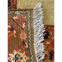 Moroccan amber ground thick pile rug, the plain ivory field decorated with a central pole medallion of star form, the wide guard bands decorated with repeating geometric and foliate patterns