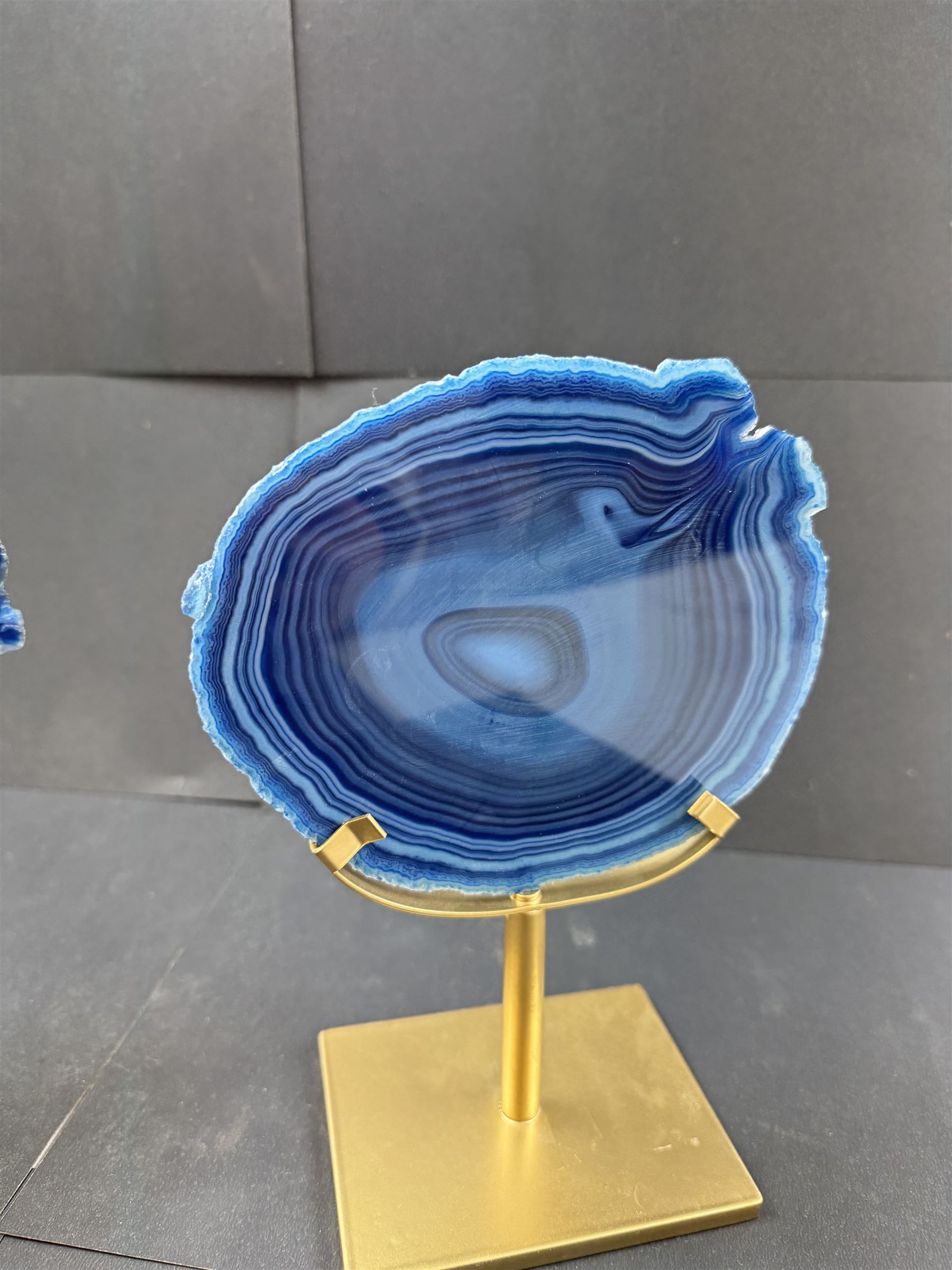 Pair of blue agate slices, polished with rough edges, raised upon gilt metal stands, H20cm