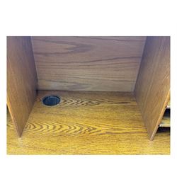 Early 20th century oak tambour roll-top desk, the top with fitted interior including drawers, pigeonholes and compartments, the twin pedestals fitted with four drawers with carved handles, supported by plinth base 