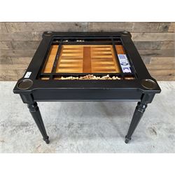 Ebonised square games table, reversible chessboard top revealing games compartment