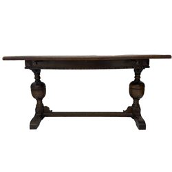 Early 20th century oak extending table, moulded rectangular top, pull-out action with fold-out leaf, on turned cup and cover pedestals and sledge feet, united by moulded stretcher 