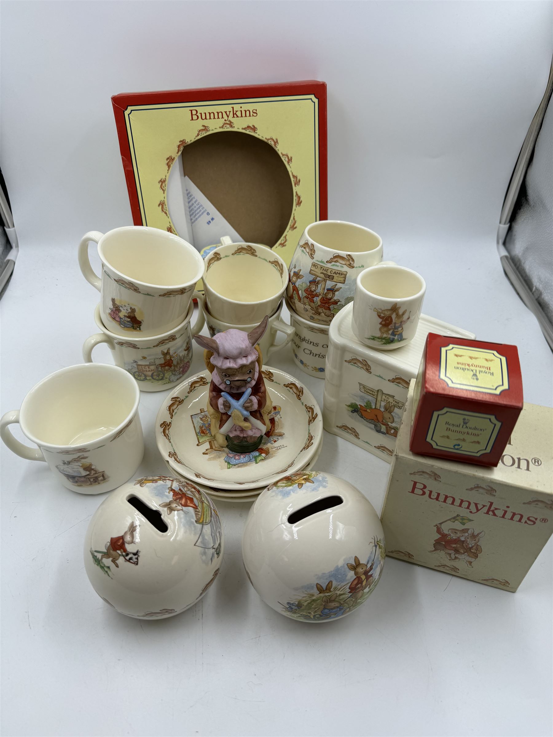 Royal Doulton Bunnykins teawares, including teacups and saucers, egg cup, money boxes etc (12)