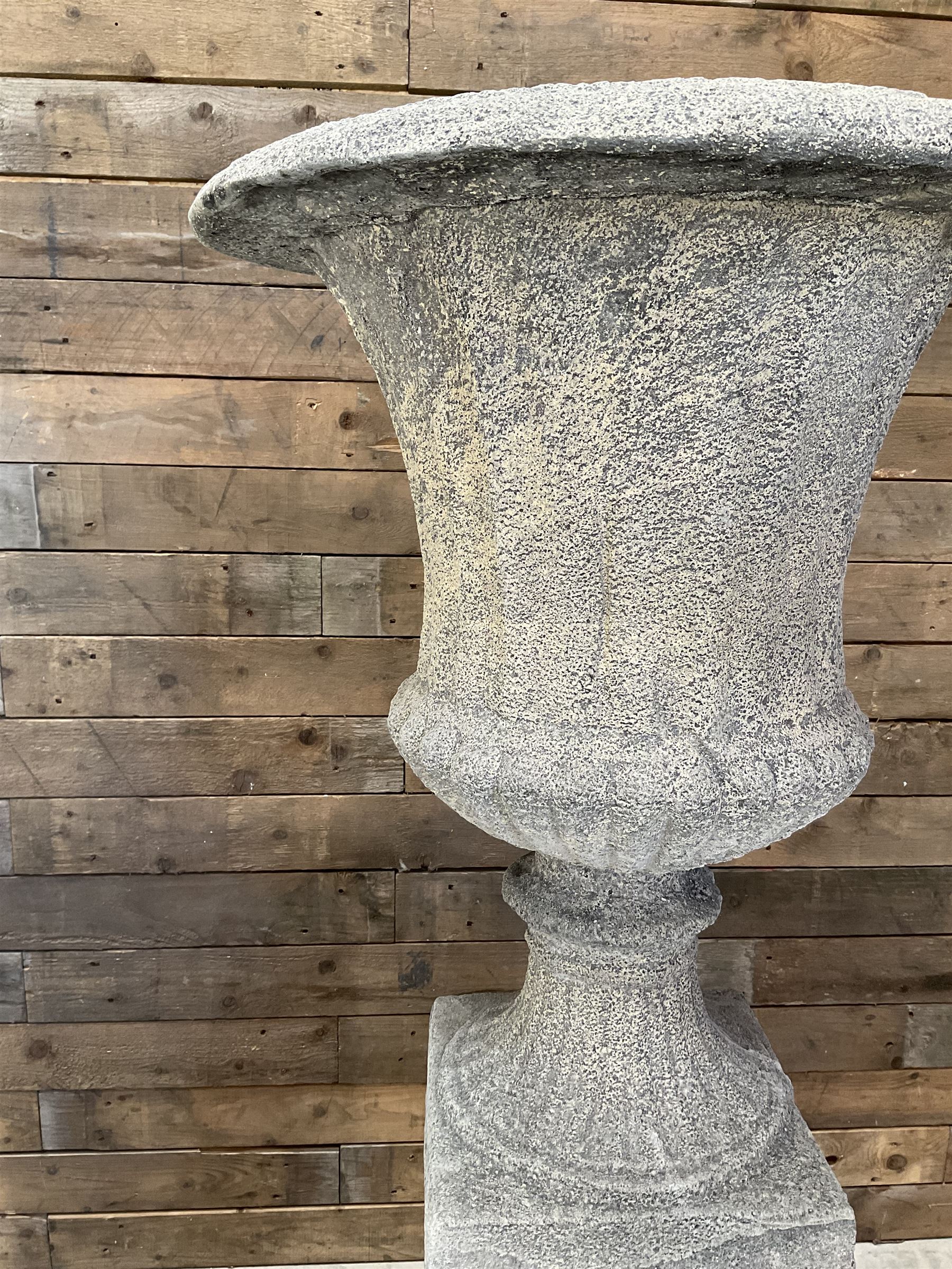 Pair of large Georgian design cast stone garden urns, egg and dart border, tapering column on square base, raised on square column