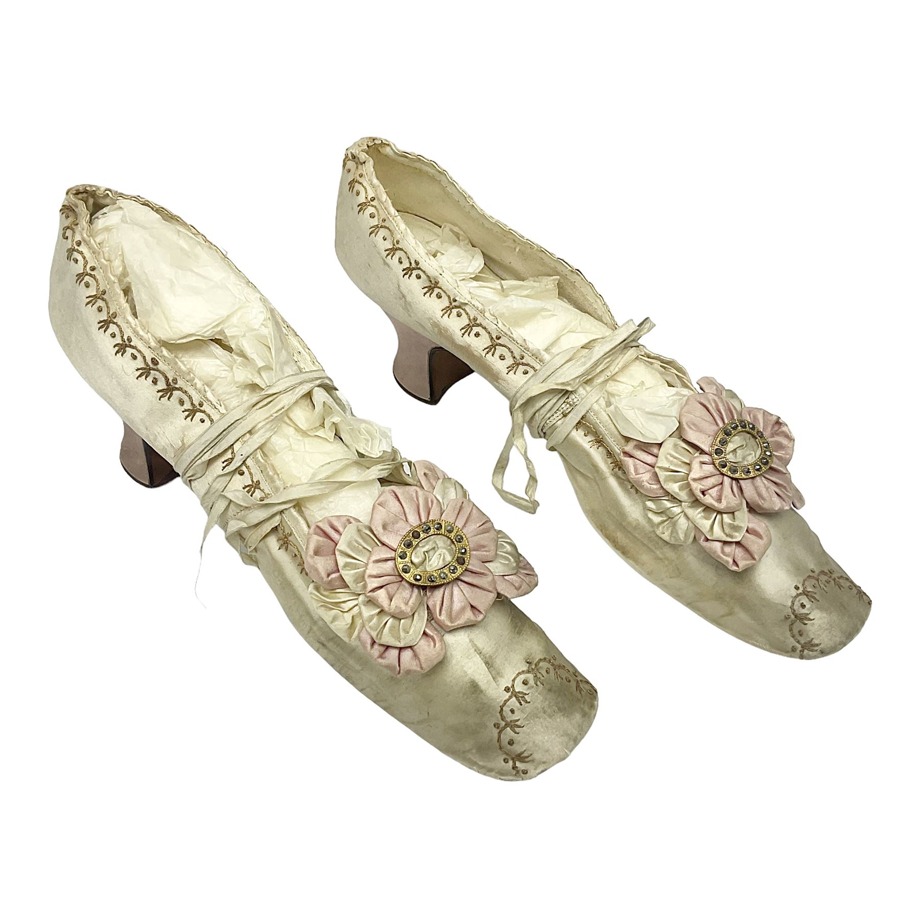 Pair of 19th century ivory silk satin ladies shoes, with rosette to the vamp, with pink silk satin heel, L23cm