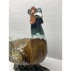 Large stoneware sculpture modeled as a Ring Neck Pheasant, upon a naturalistic base, H55cm, L78cm