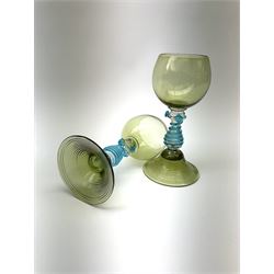 A set of eight German green glass hock glasses, with trailed spiral and prunt detail to the baluster stems, upon domed feet, H15.5cm.