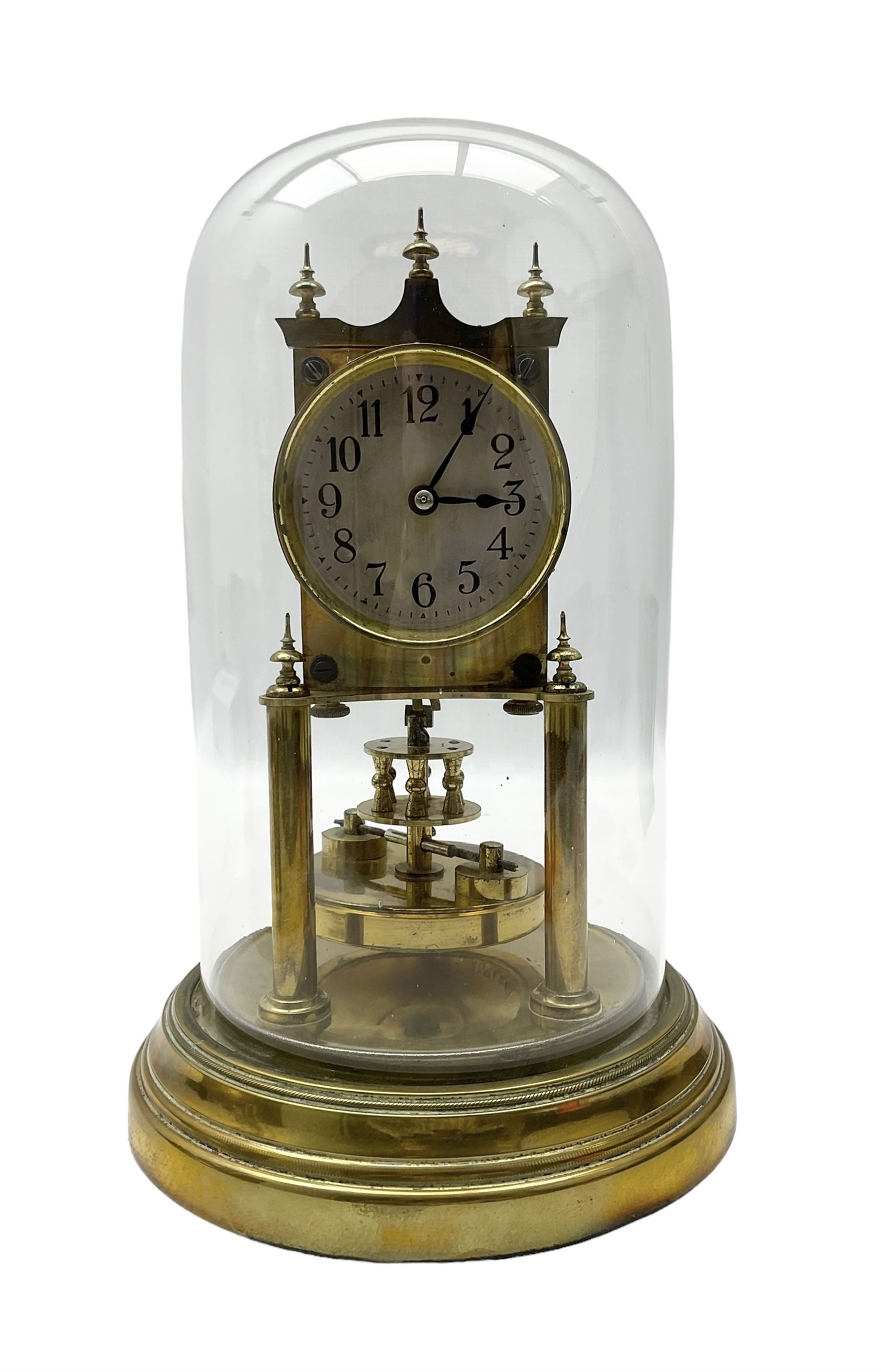 Gustav Becker - German torsion clock, serial No 2086578, on a circular brass base with a glass dome, silvered dial with Arabic numerals and steel spade hands, circular oscillating pendulum, torsion spring intact.