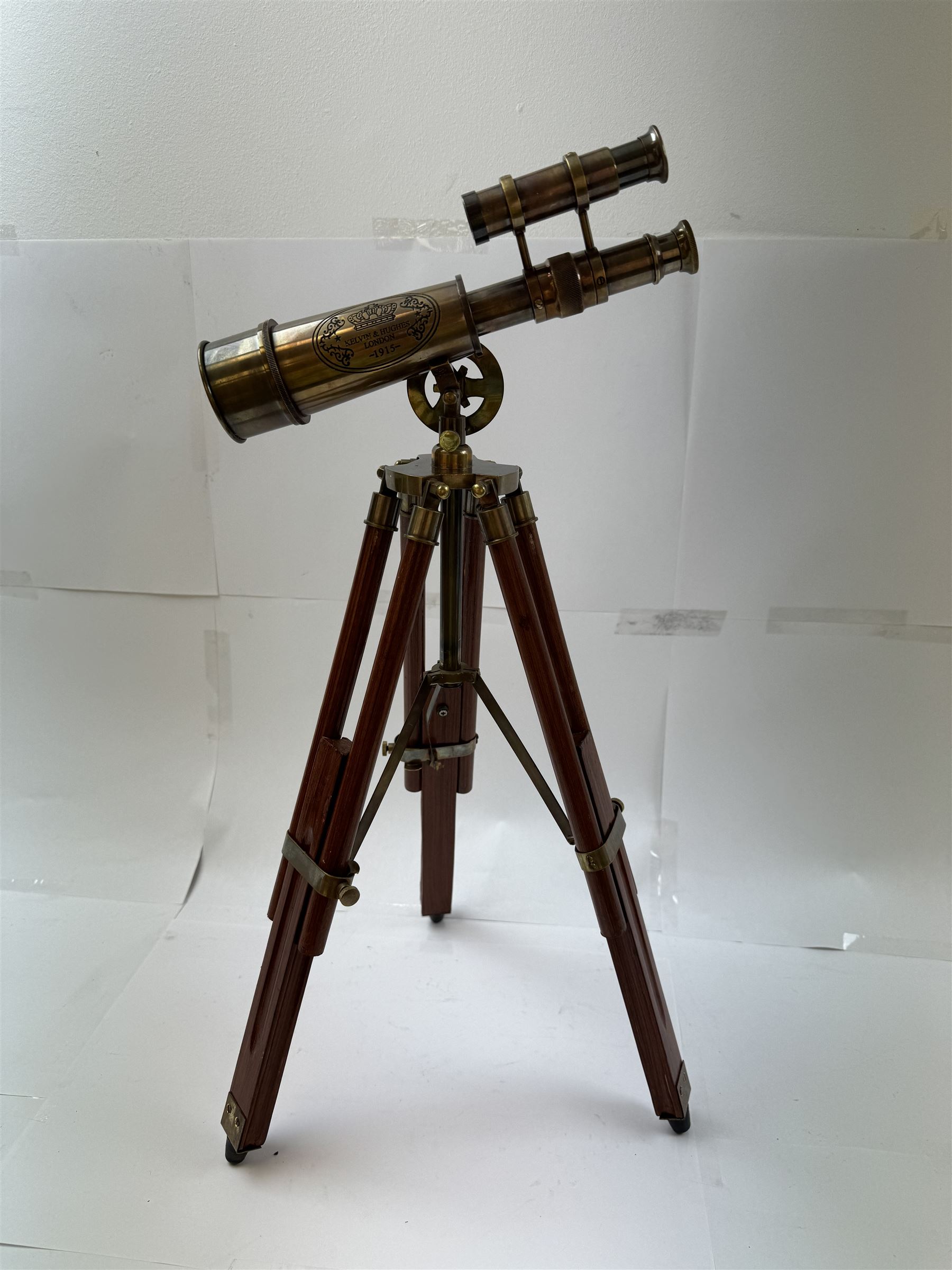 Brass telescope upon a wooden adjustable tripod, H55cm 