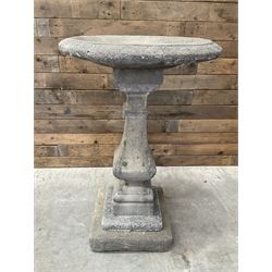 Cast stone garden bird bath, circular dished top, raised on square tapering column, on stepped base with separate mounting plinth