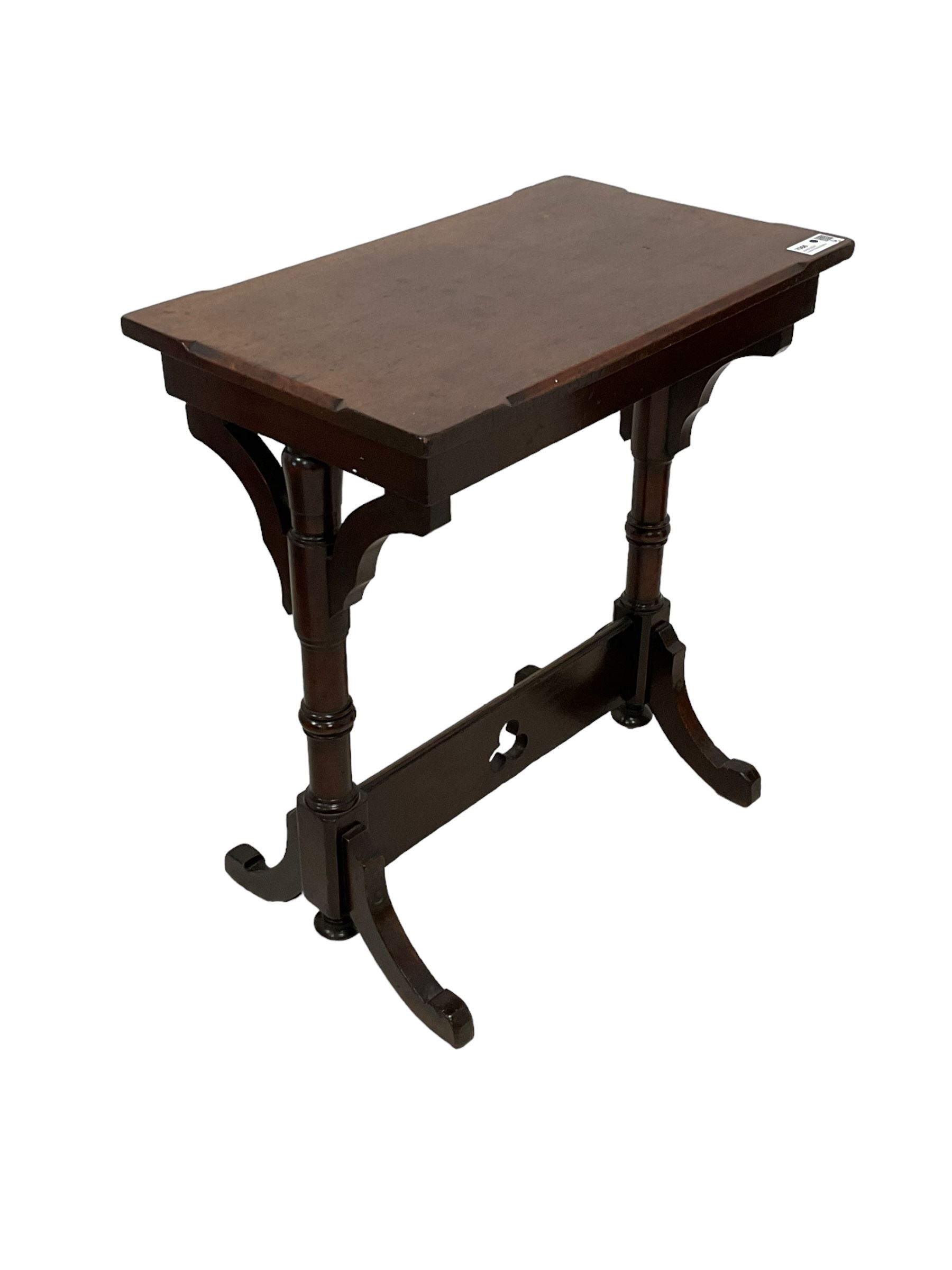 Late Victorian walnut ecclesiastical side table, rectangular top with stop chamfered edge, on turned supports united by rectangular stretcher pierced with trefoil, on splayed feet 