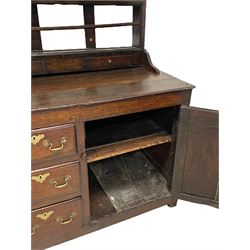 18th century oak dresser, projecting cornice over three heights plate rack with three small drawers, rectangular ovolo-moulded top over three central drawers and two flanking cupboards, enclosed by fielded panelled doors, on stile supports 