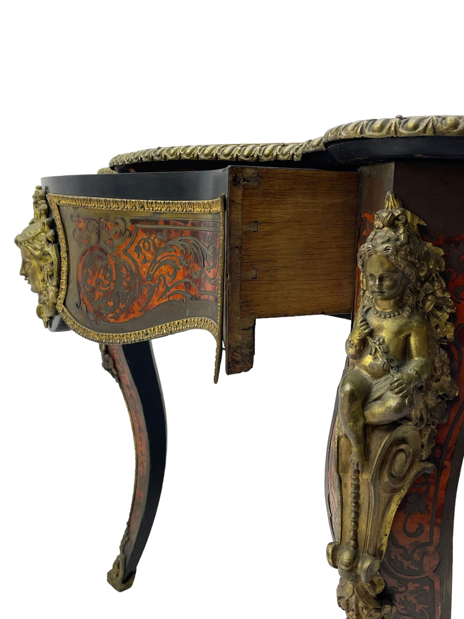 Victorian Louis XV design boulle work centre table, shaped form, decorated extensively with brass and red tortoise shell scroll work, central extending acanthus leaves surrounded by scrolling foliage, gardroon and floral cast brass edge, the frieze rails decorated with further boulle work and green man gilt metal cast masks, the cabriole supports mounted by seated putti mounts on S-scroll brackets surrounded by oak leaves and acorns, ornate scroll and floral cast terminal caps