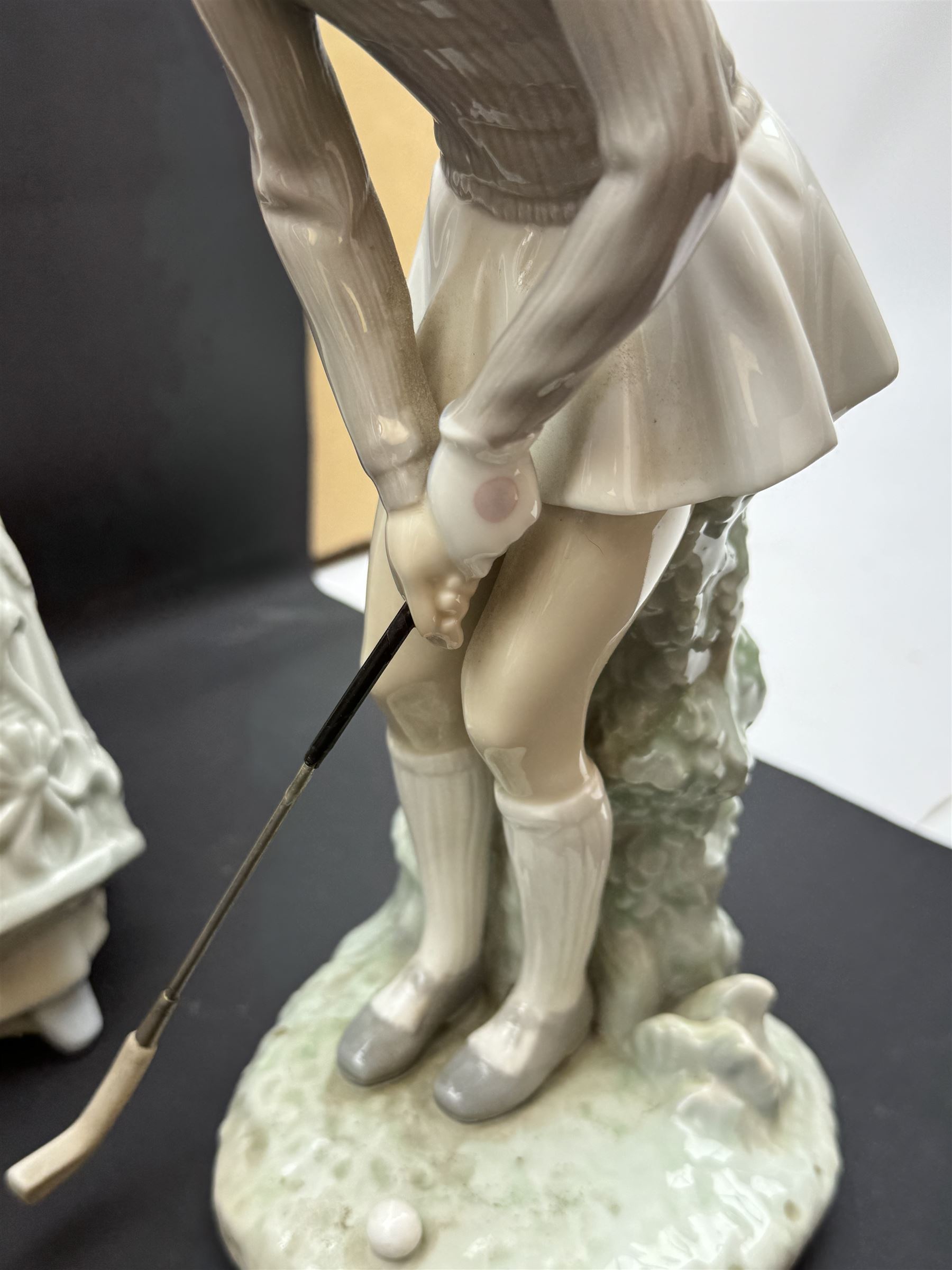 Group of Lladro figures, to include May Dance no 5662, examples modelled as a female golfer, young woman holding sheep in her arms, pair of figures in pink dressed holding sun hats, etc., together with two Nao figures and a further Spanish example, (11)