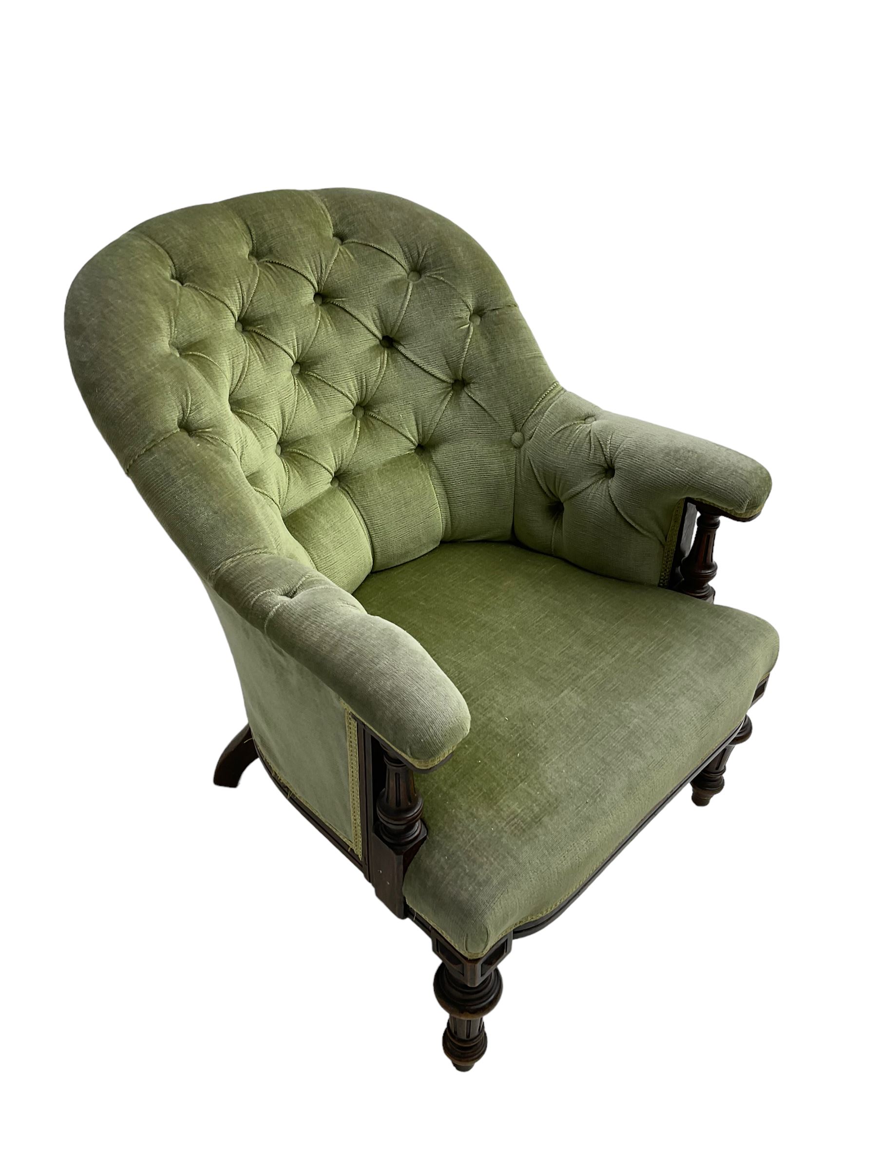 Victorian mahogany framed armchair, upholstered in buttoned sage green fabric with sprung seat, raised on turned and fluted front supports with matching arm terminal column supports