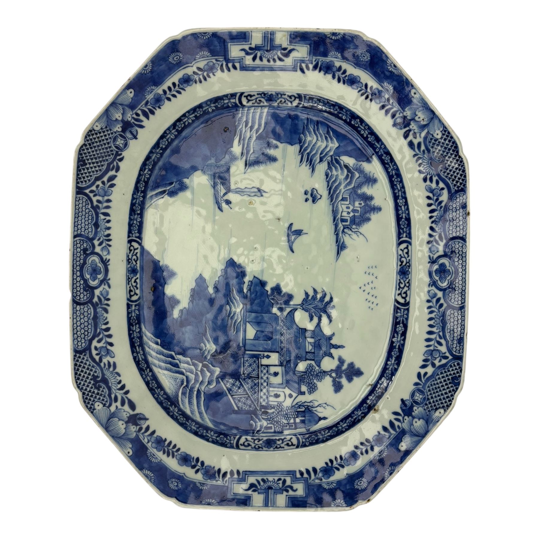 Six 18th century Chinese Export blue and white platters, each of rectangular canted form decorated with various landscape scenes, within foliate borders, max L45cm (6)