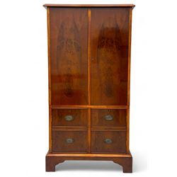 Wade - yew wood hi-fi cabinet, moulded rectangular hinged top over double-door cupboard with figured veneer, enclosing three adjustable shelves, lower section fitted with two cupboards to resemble four drawers, enclosing three drawers and open storage