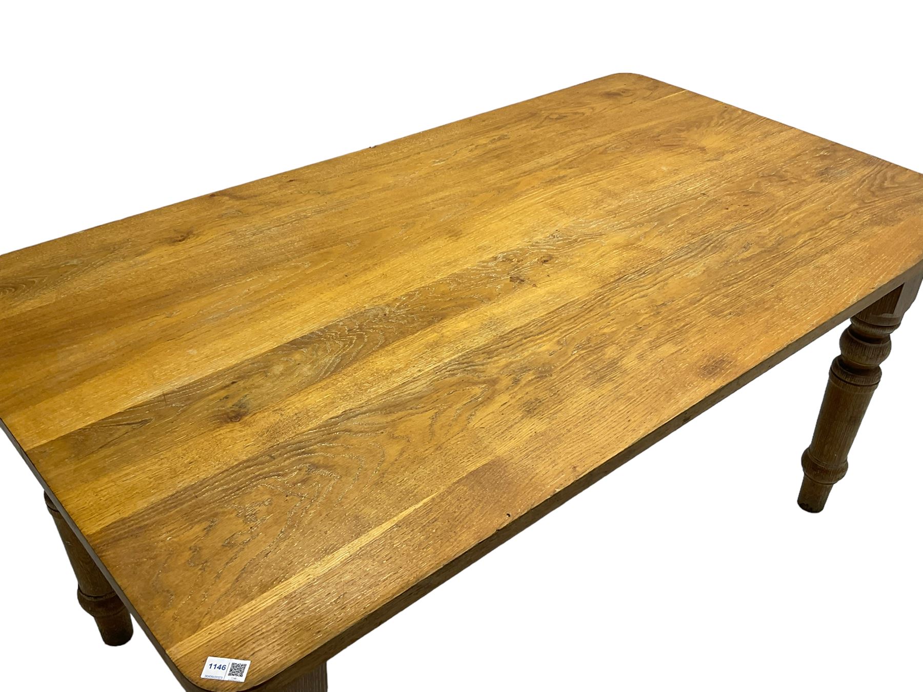 Limed oak dining table, rectangular top with rounded corners, on turned supports