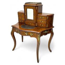 19th century French figured walnut Bonheur de Jour or writing desk, the upper section with brass gallery over mirror glazed cupboard and a combination of drawers, shaped and moulded top with leather inset and satinwood band, fitted with single drawer, on cabriole supports, inlaid throughout with scrolling foliate decoration in boxwood, ornate cast brass mounts 