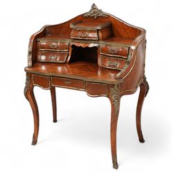 Early 20th century Louis XV design Kingwood and ormolu mounted bonheur du jour, shaped raised back fitted with five drawers and central recess, surmounted by scrolling foliate casting and pierced gallery, single frieze drawer with sliding top inset with crushed velvet, on cabriole supports mounted by mask castings with extending floral decoration, the sides and drawer fronts inlaid with parquetry panels 