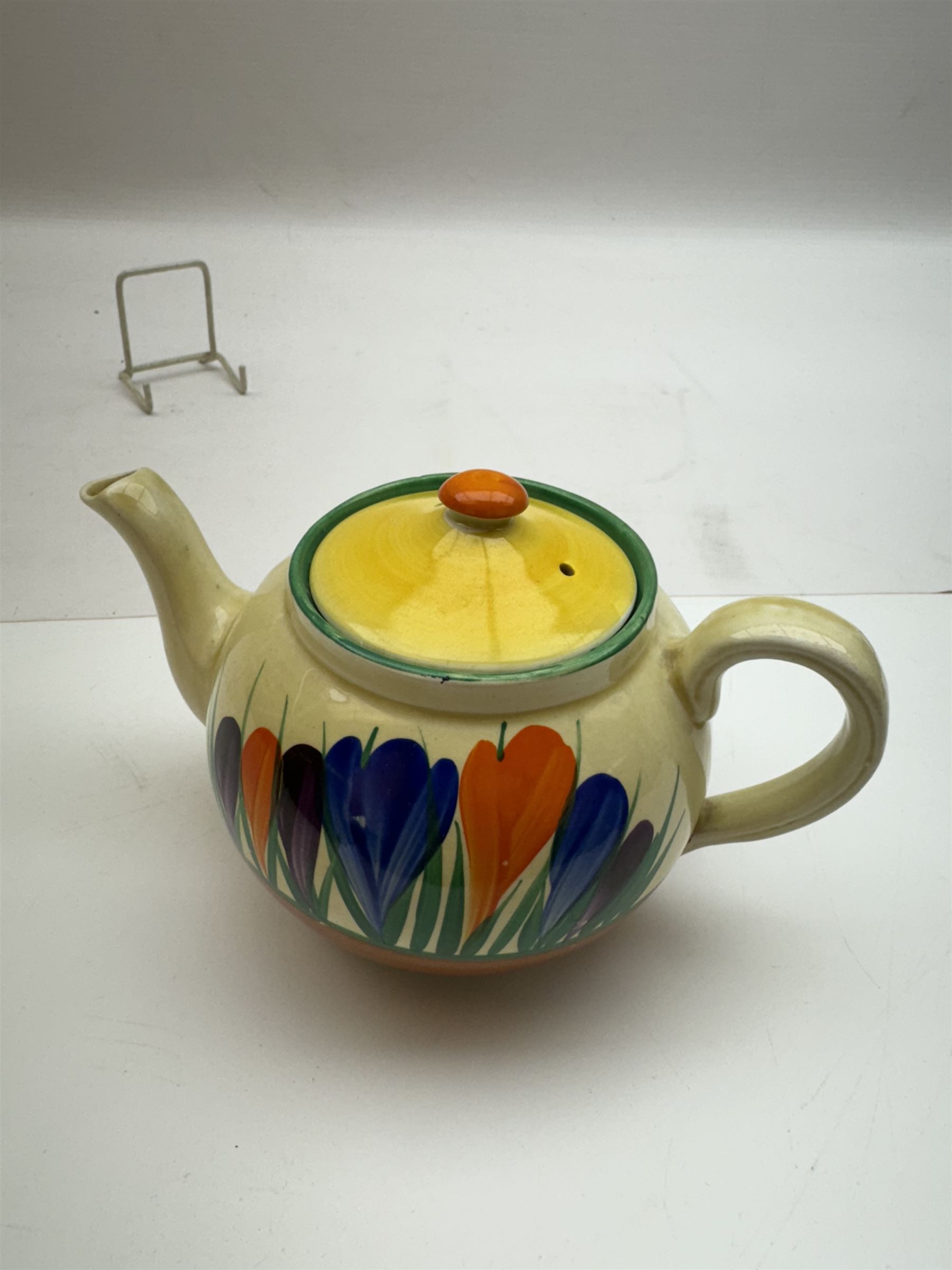 Clarice Cliff Bizarre 'Crocus' pattern teapot, H10cm, together with a Clarice Cliff Bizarre 'Crocus' pattern plate, D23cm, each with Crocus and Bizarre marks beneath, (2)