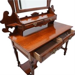 Late Victorian walnut dressing table, raised swing mirror back over two trinket drawers with brass Art Nouveau handle plates, rectangular top fitted with two further drawers, raised on square ring-turned supports united by shaped under-tier, on castors