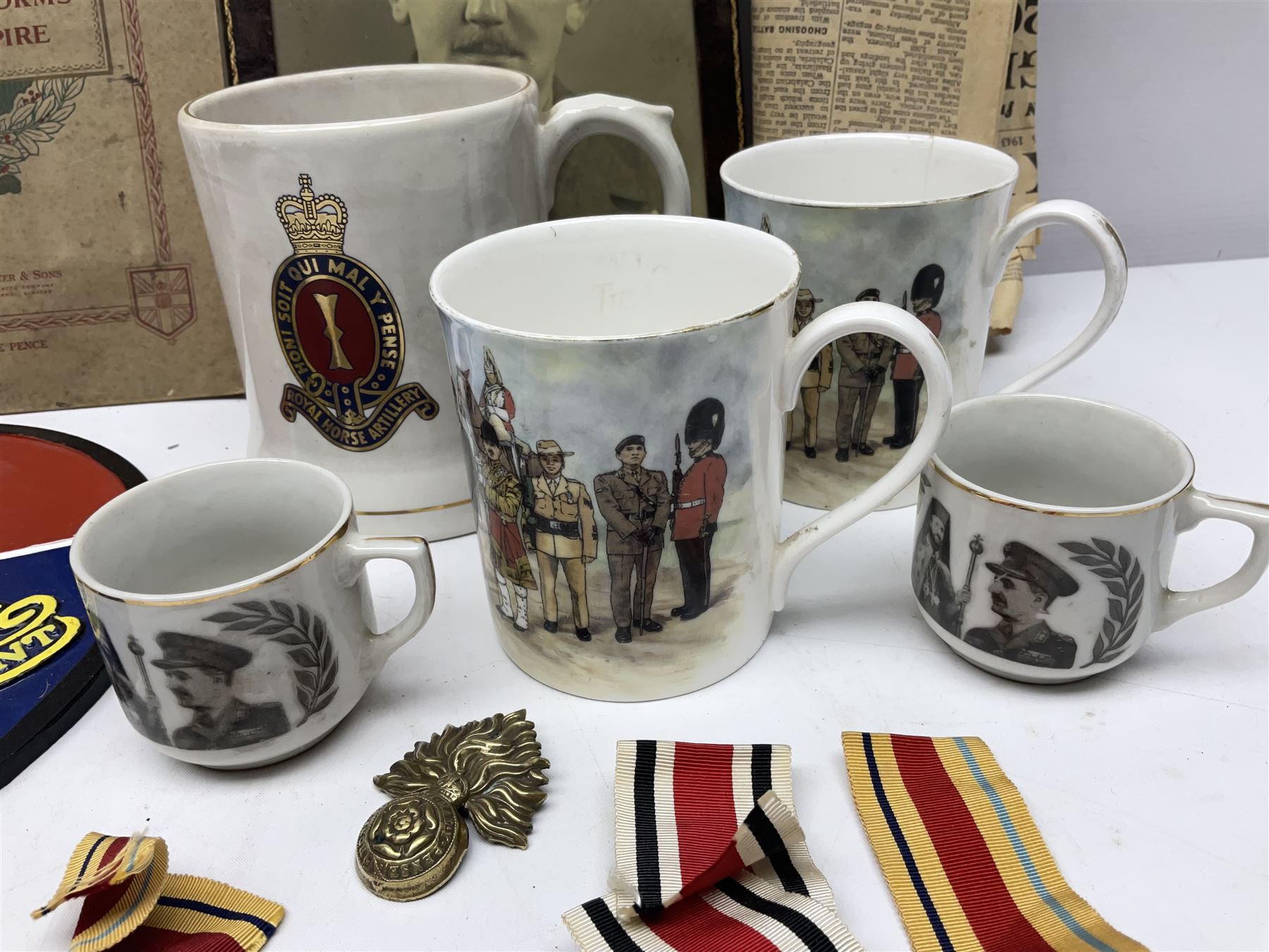 Collection on military items, including John Player & Sons Military Uniforms of the British Overseas, medal ribbon, ceramics and a reproduction metal plaque 