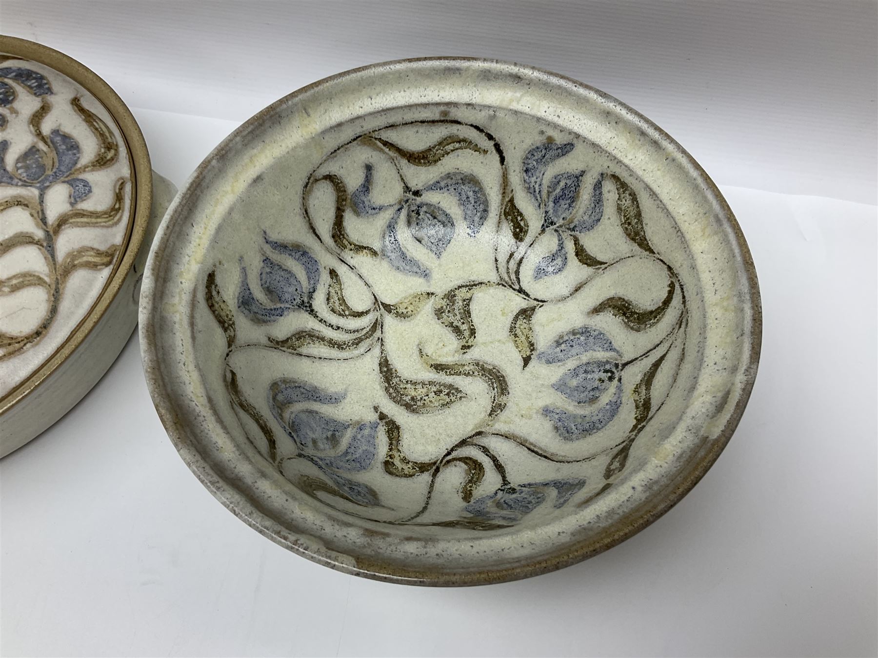 John Egerton (c1945-): studio pottery stoneware, comprising twin shallow covered dish, serving bowl and eight dessert bowls, all decorated with flowering sprigs on a cream ground, dish D28cm