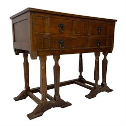 Arts & Crafts design oak chest on stand, rectangular top over two short and one long drawer, on a series of shaped and tapered supports with carved and beaded decoration, united by chamfered stretchers rails, on sledge feet 