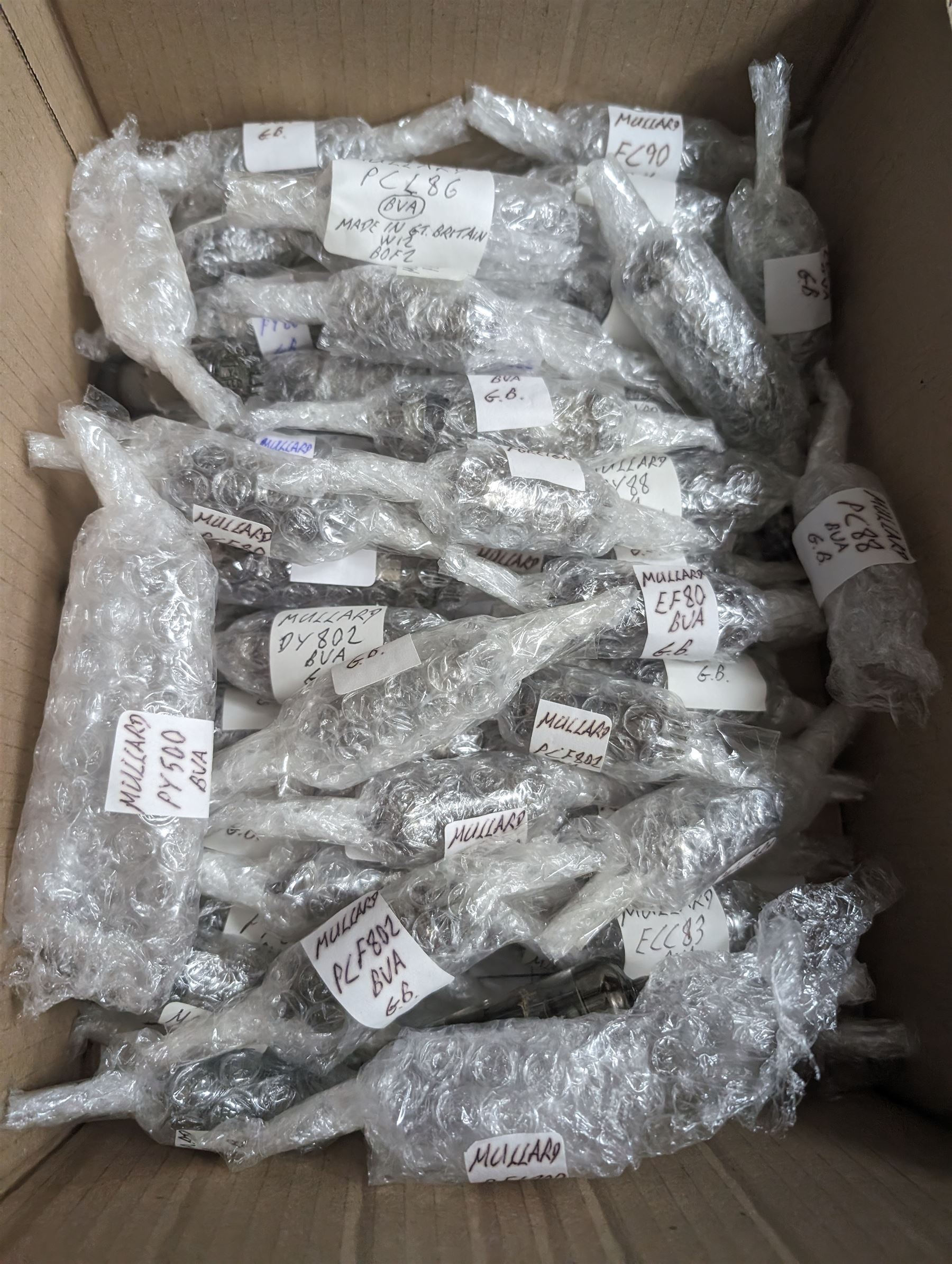 Large collection of Mullard thermionic radio valves/vacuum tubes, including boxed examples and bubble wrapped examples identified with lists