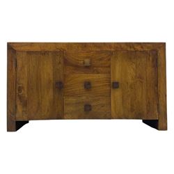 Contemporary Dakota mango wood sideboard, plain rectangular top over three central drawers flanked by cupboards with shelving, each with square pulls, raised on stile supports