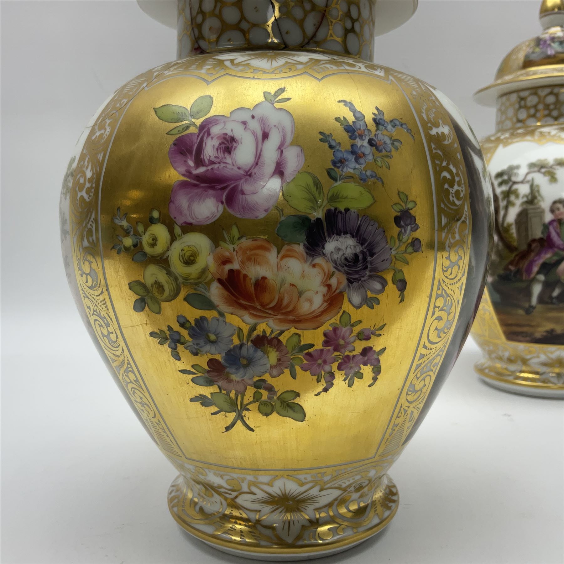 Pair of late 19th century Helena Wolfsohn vases and covers, each of baluster form with domed cover, painted with alternating panels of romantic scenes and floral sprays upon gilt ground, with Augustus Rex mark to base, H27cm