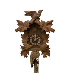 German 1960's cuckoo clock with automata - traditional styled case and dial with a cuckoo sounding the hours and half-hours, twin chain driven movement and automata feature of two carved cuckoos to the front of the case simultaneously moving as the hours are struck. With weights and pendulum.  