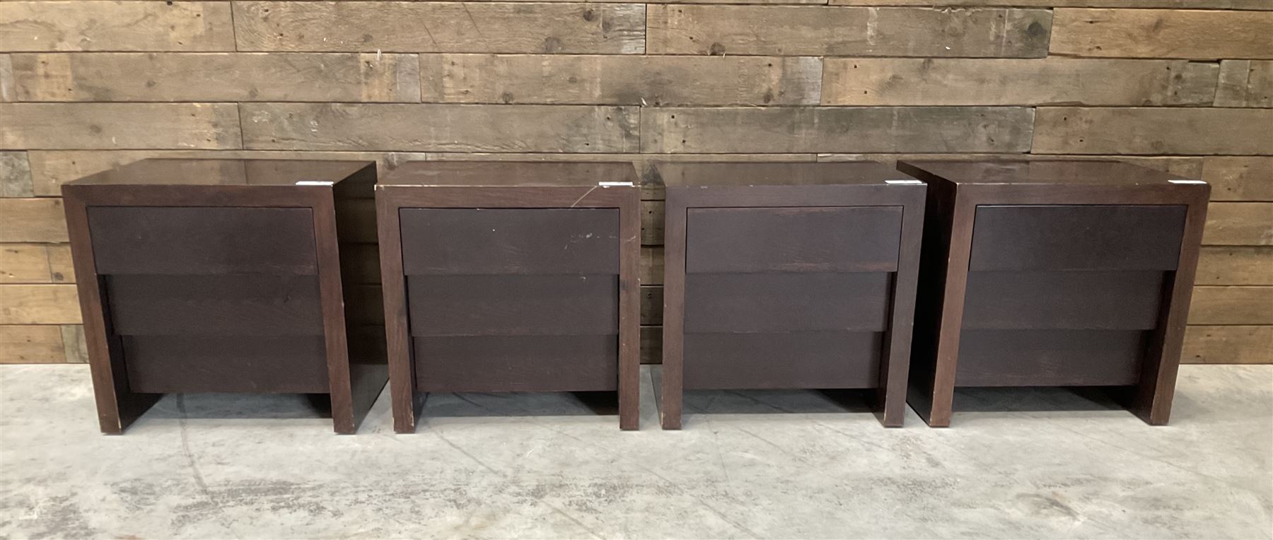 Four rosewood bedside chests, fitted with three stepped soft-close drawers