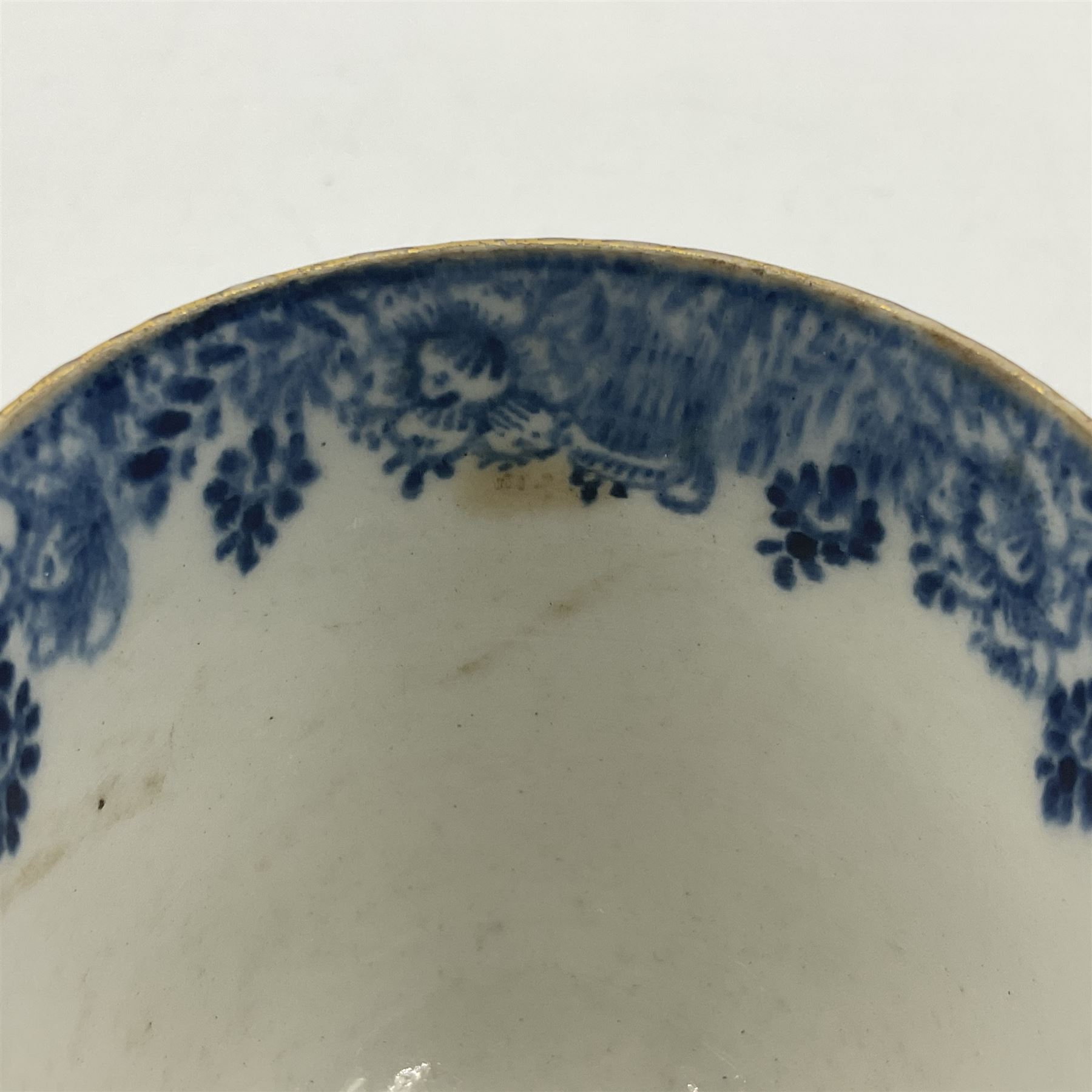 Rare 18th century Bow porcelain coffee cup, circa 1765-1770, profusely decorated with figures and dwellings in a rocky landscape, the interior with wide foliate border, H6cm