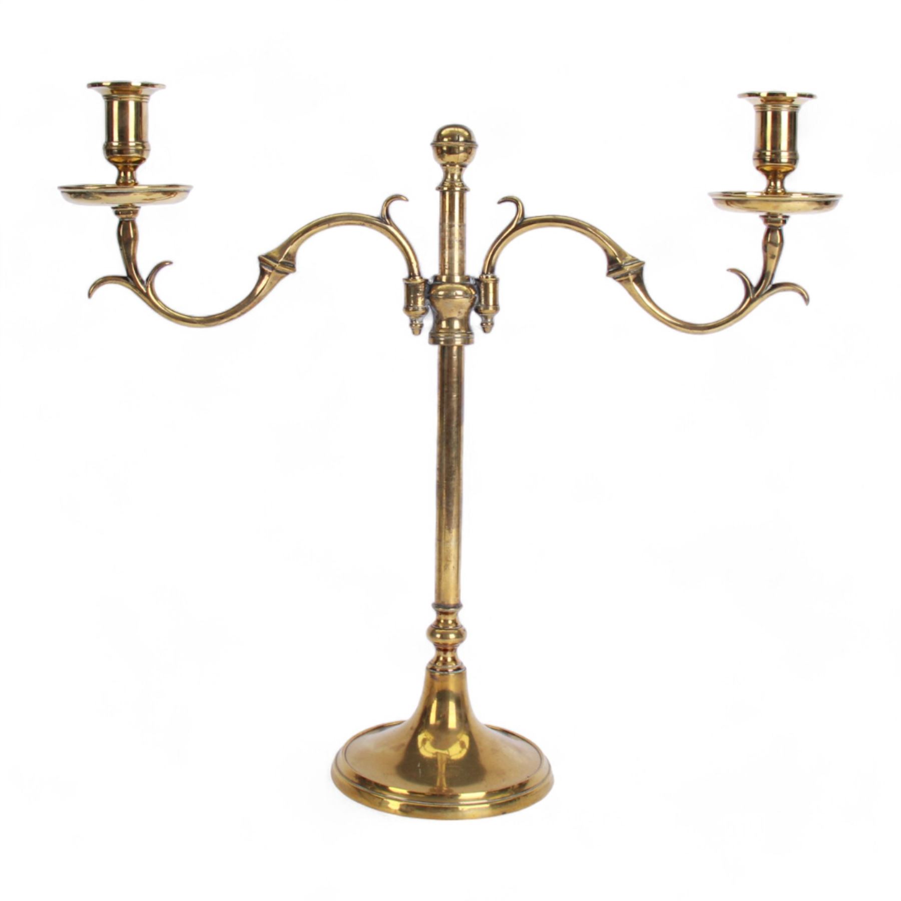 19th century brass adjustable candlestick, the spreading circular base leading to a basal knopped stem supporting adjustable twin scroll arms with urn shaped sockets above circular drip pans, H38cm W43.5cm