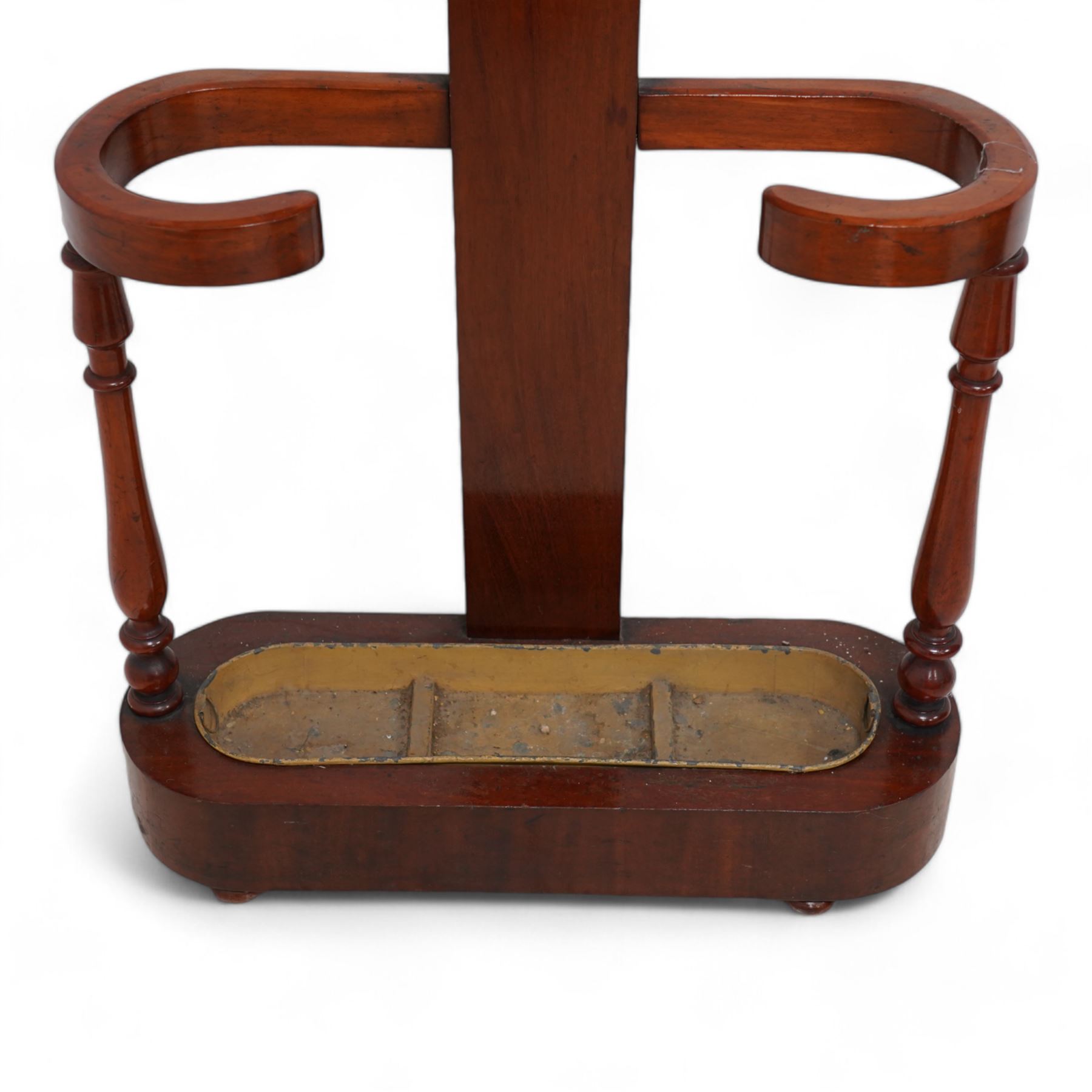 Victorian mahogany hall stand, central rectangular pillar supporting four projecting branches with turned hat and coat hooks, lower stick and umbrella stand on turned supports with metal drip tray, skirted base on compressed bun feet 