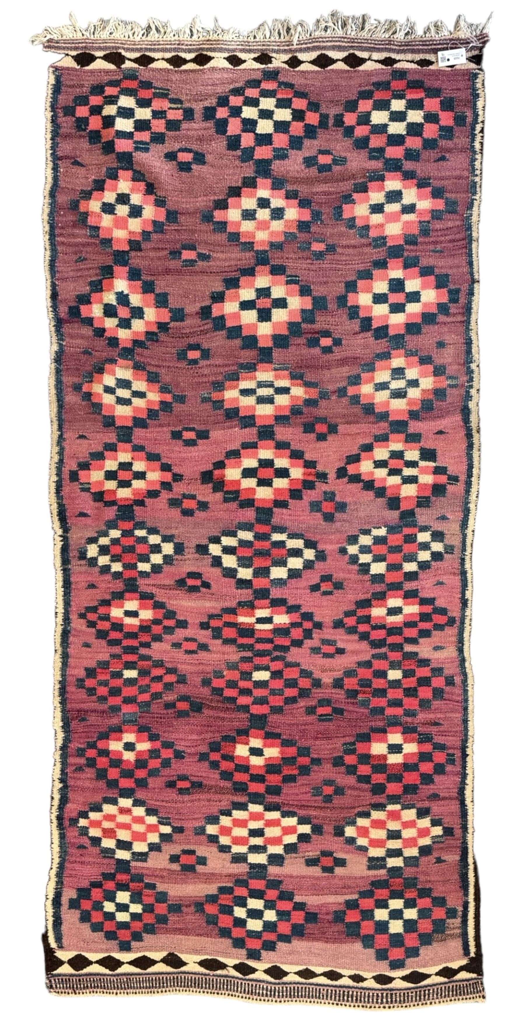 Turkish Anatolian lilac ground kilim rug, the field decorated with three columns of geometric lozenges, enclosed by plain guard stripes 