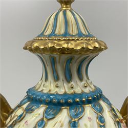 Pair of late 19th/early 20th century Sevres style vases and covers, of baluster form with gilt scroll handles and domed covers, the wrythen fluted bodies decorated with alternating bands of painted fruit and flowers and gilt vines, upon a white and celeste blue ground, with printed and impressed marks beneath, H22.5cm 