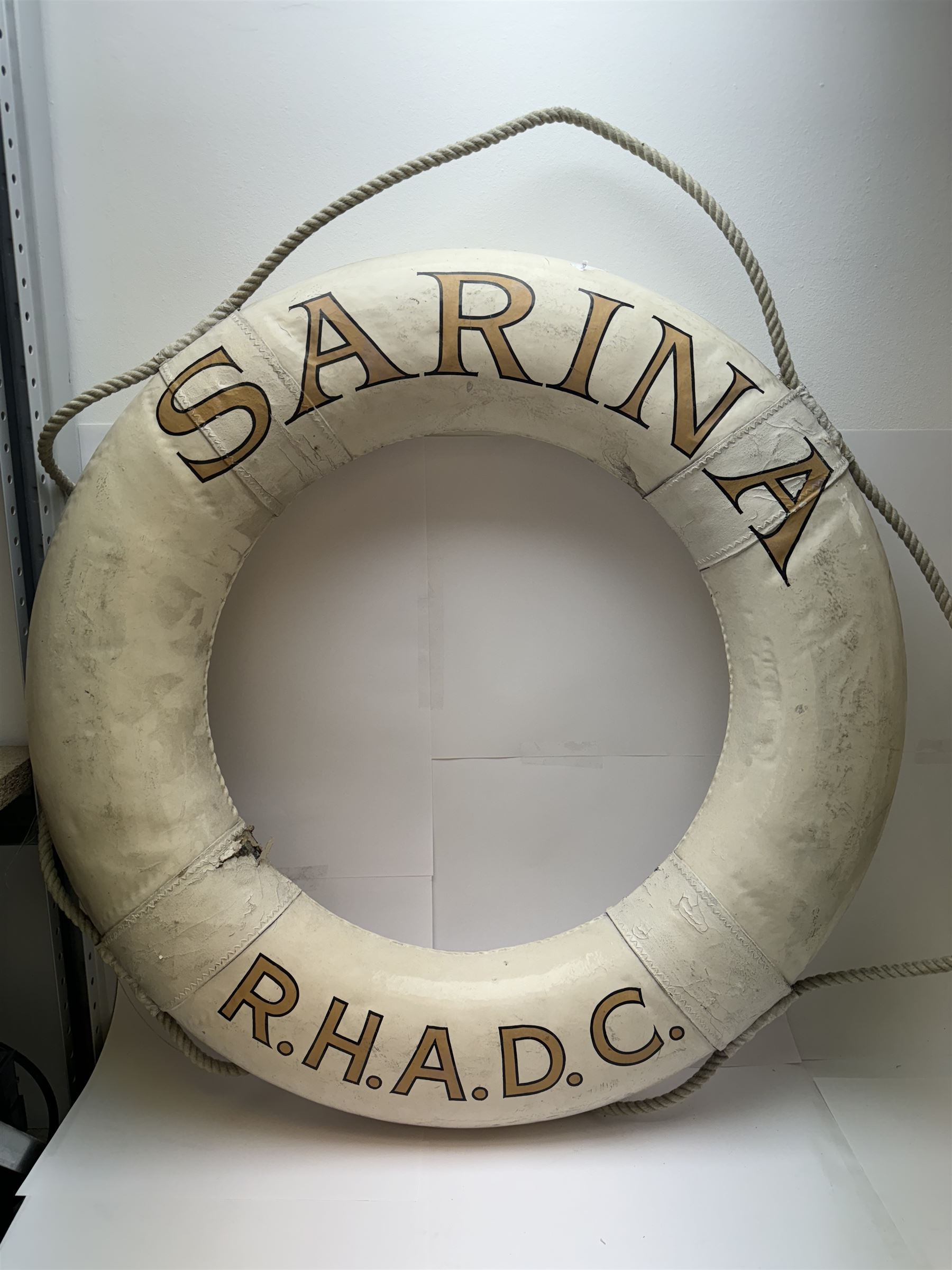 Four mid 20th century yacht lifebuoys, each painted in gold and black lettering 'Sarina R.H.A.D.C', upon a white ground, D68cm