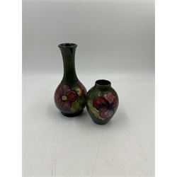 Two small Moorcroft vases decorated in the Anemone and Hibiscus on green grounds, with markers mark beneath, largest H16cm 