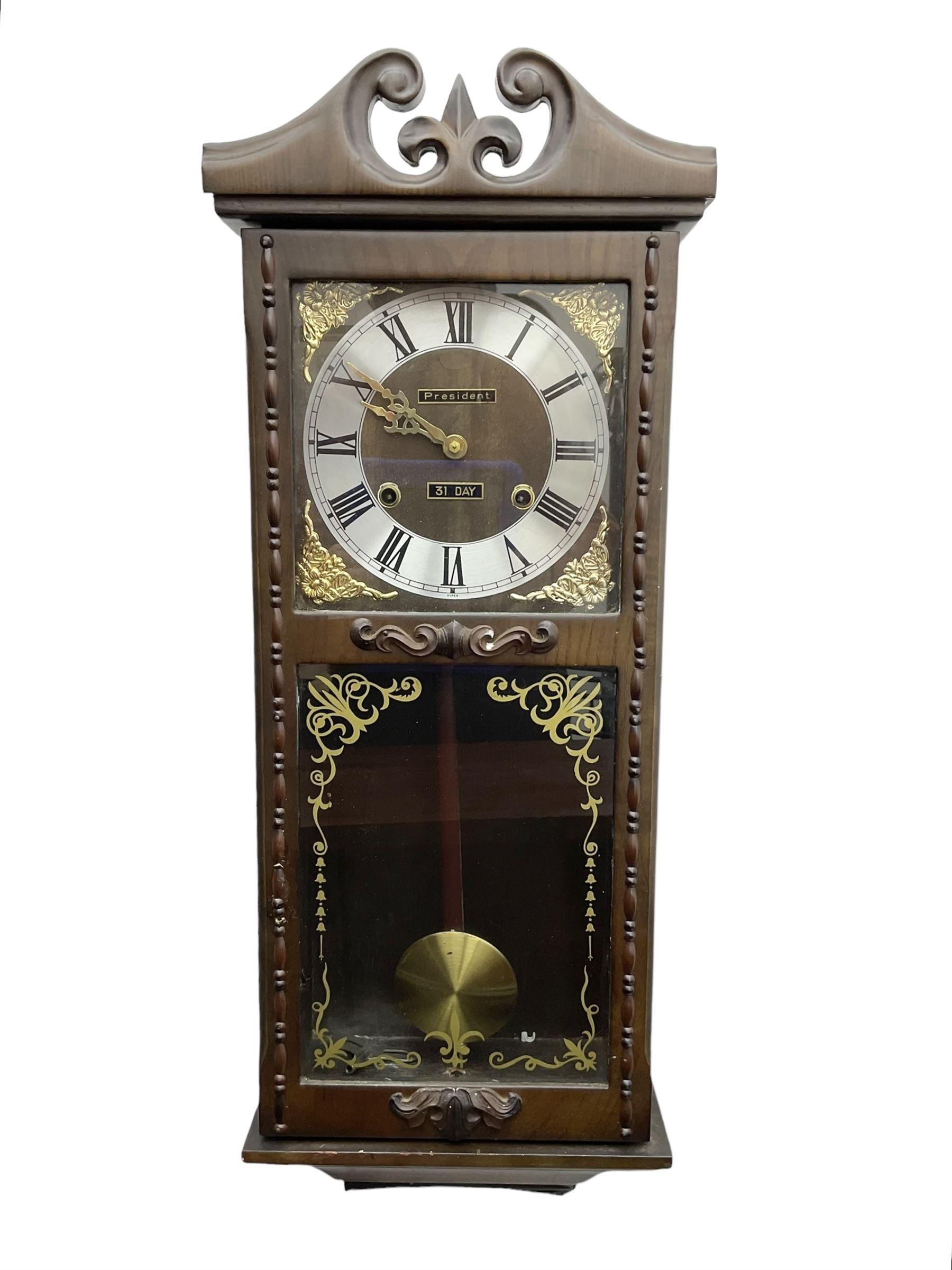 Month going twin train spring driven wall clock - in a glazed oak case with a swan necked pediment, silvered chapter ring with Roman numerals and gilt hands, with cast brass spandrels and a visible pendulum, striking movement, sounding the hours and half hours on a gong.