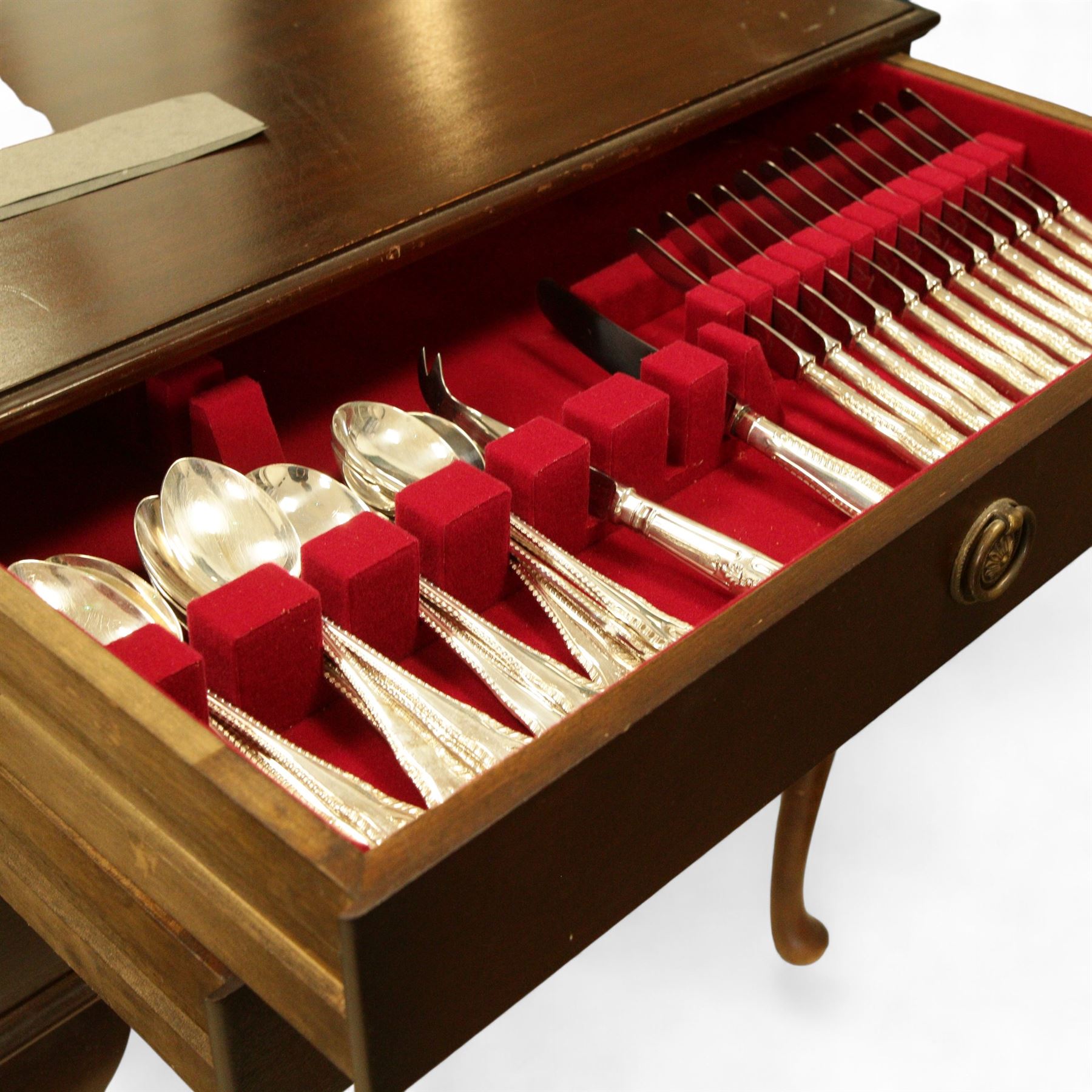 George Butler & Co. canteen of silver plated cutlery, for eight persons, plus additional cutlery, including a set of six silver teaspoons, pair of white metal salad servers and various silver-plated and brass flatware, in a three-drawer mahogany canteen case raised on cabriole legs