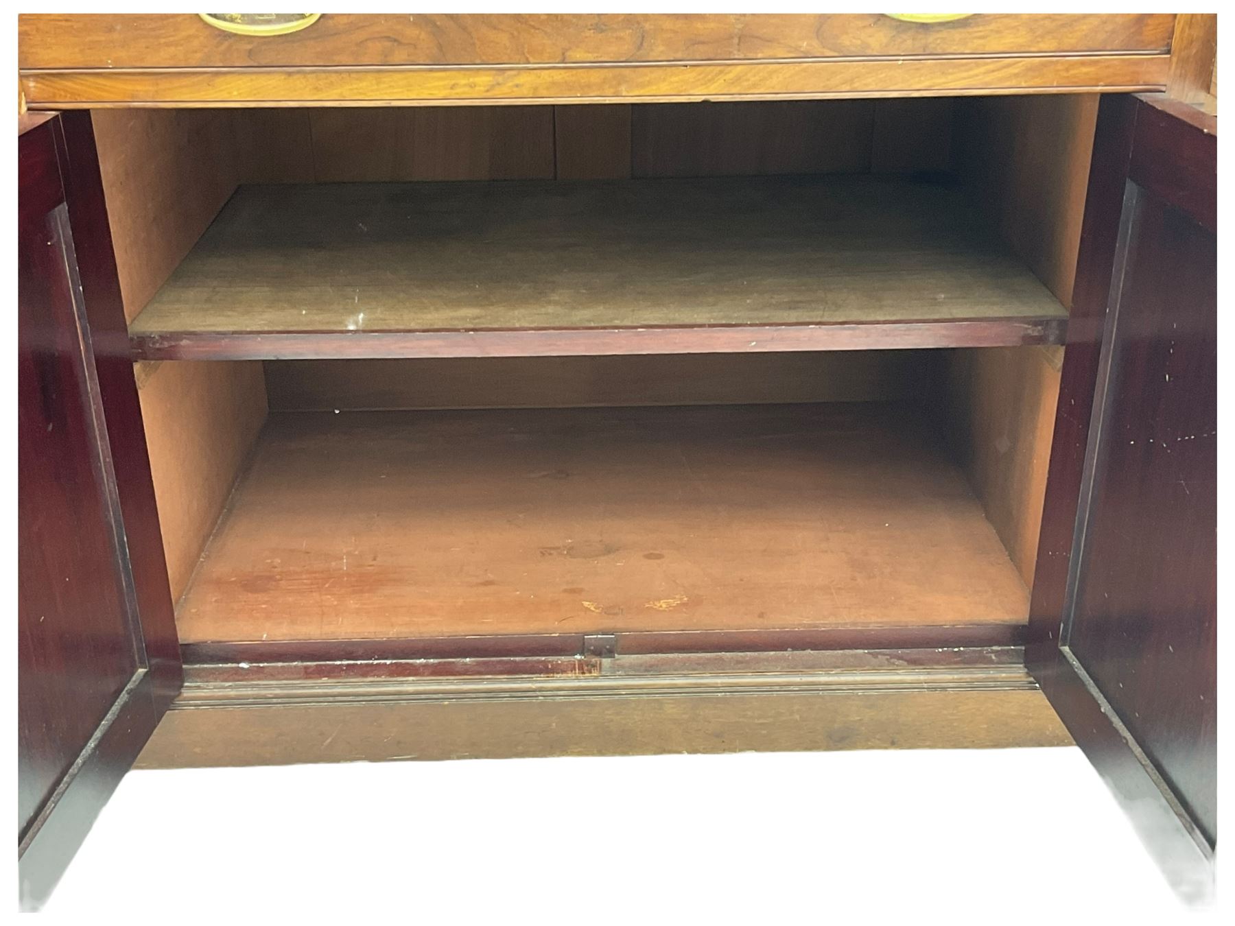 Victorian walnut clerk's desk, raised central section with tambour roll over hinged top, the interior fitted with leather inset writing surfaces, small drawers, document divisions and pen and ink stand, central drawer over double panelled cupboard, flanked by two banks of four graduating drawers, on bracket feet 