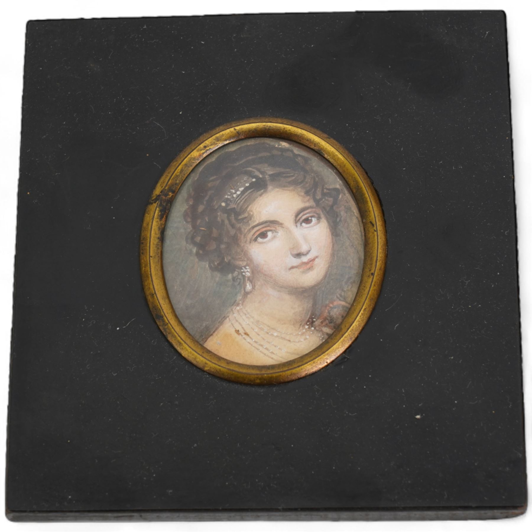 English School (19th century): Portrait of a Mediterranean Beauty with a Pearl Earring, miniature watercolour on paper unsigned 6cm x 5cm