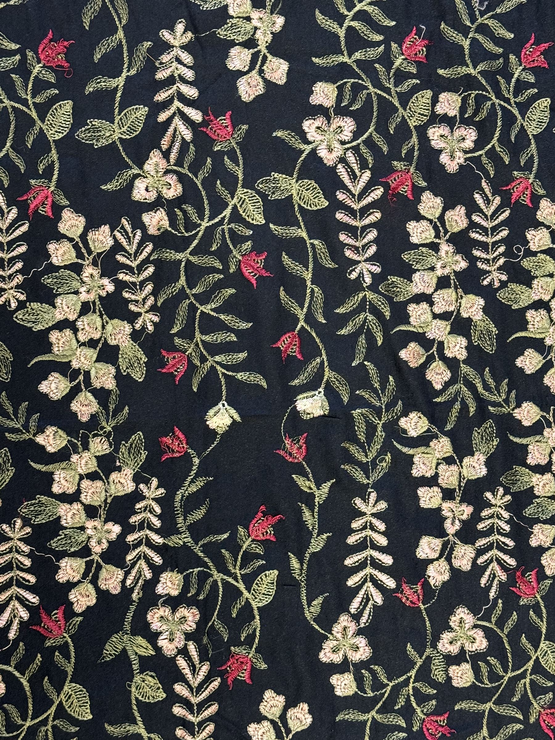 Embroidered Karandi fabric runner, the field featuring a black ground with an all-over floral design, including large pink and cream roses, accompanied by green leaves and small blossoms, bordered by plain sections at each end