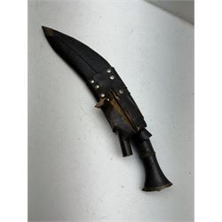 British Service issued Kukri, circa 1980s, with curving blade, hardwood and brass grip in leather covered scabbard with two skinning knives, blade, stamped 12th  December 1980 Dharan Nepal to blade, blade L28cm, overall L39cm